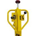 Yellow mechanical device with a spring and red button on a white background