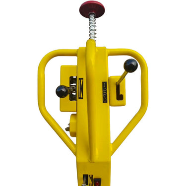Yellow mechanical device with a spring and red button on a white background