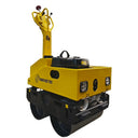 Yellow construction roller with black wheels on a white background