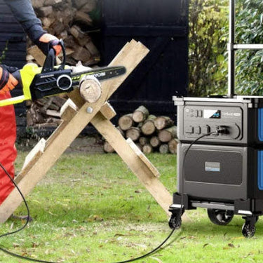 Person using a chainsaw with a portable generator in an outdoor setting