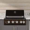 A built-in outdoor gas grill with a black lid and dark brown control panel, installed in a modern kitchen setting with gray cabinets, a white marble countertop, and a light wood backsplash.