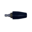 A black plastic pressure washer nozzle tip with a brass fitting and silver metal connector, placed on a scratched, light gray surface.