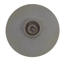 A beige plastic circular disc with a central hole, likely a replacement part, placed on a scratched light gray surface.
