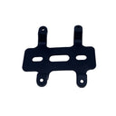 A black metal mounting bracket with four bolt holes, photographed on a light gray textured surface.