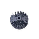 A small metallic silver impeller or fan blade component placed on a scratched light gray surface.