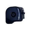 A small black plastic automotive part, likely a fuel door switch or trim component, placed on a scratched light gray surface.