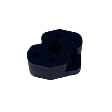 A small black plastic mechanical component or adapter, photographed on a scratched, light gray metal surface.