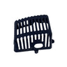 A small black plastic component with a slotted top and a circular cutout, photographed on a light gray textured surface.