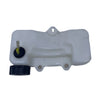 A translucent white plastic reservoir tank with a black cap and a brass filler tube, photographed on a scratched white surface.