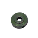 A small circular metal pulley or sprocket with a star-shaped hole in the center, finished in a muted olive green, resting on a scratched light gray surface.