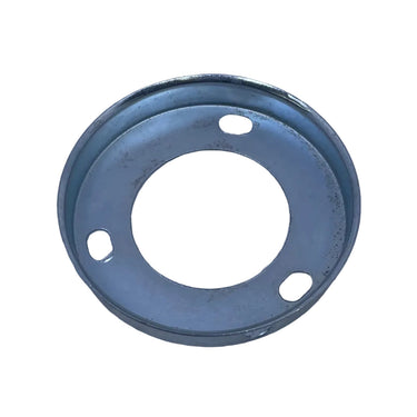 A small circular metal gasket or flange with three mounting holes, shown on a scratched light gray metal surface.