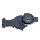 A used metal automotive water pump housing with a pulley and belt cover, photographed on a scratched light gray surface.
