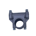 A small metallic gray mechanical clamp or coupler with two side bolts, photographed on a scratched light gray surface.