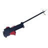 A black and red handheld spray gun with a long nozzle, photographed on a white studio backdrop with cardboard boxes visible around the edges and a person's legs at the bottom.