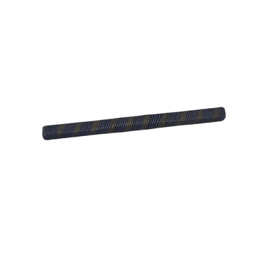 A small cylindrical metal rod with a dark gray and yellow striped pattern, lying horizontally on a scratched, light gray metal surface.