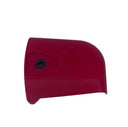 A small red plastic replacement part with a single screw hole, placed on a scratched white surface.