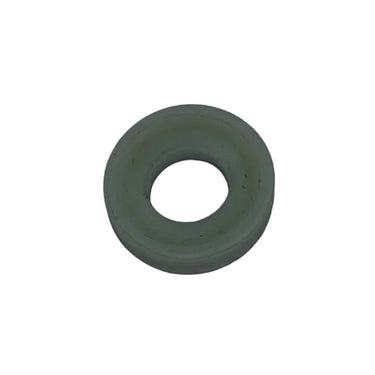 A small olive green rubber gasket or O-ring resting on a scratched, light gray metal surface.