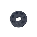 A small circular gray plastic drain stopper or filter component resting on a scratched, light gray surface.