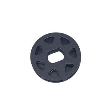 A small circular gray plastic drain stopper or filter component resting on a scratched, light gray surface.