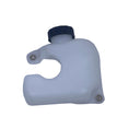 A small translucent white plastic reservoir tank with a black cap, photographed on a scratched light gray surface.