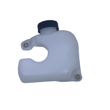 A small translucent white plastic reservoir tank with a black cap, photographed on a scratched light gray surface.