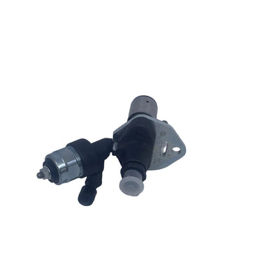 A used automotive part, likely a fuel pump assembly or similar electrical/mechanical component, resting on a scratched white surface.