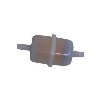 A small cylindrical plastic component with a beige inner section and white outer casing, lying on a scratched light gray surface.