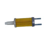 A small cylindrical electronic component with a yellow ribbed body, a white plastic tip, and two silver metal pins, resting on a scratched gray surface.