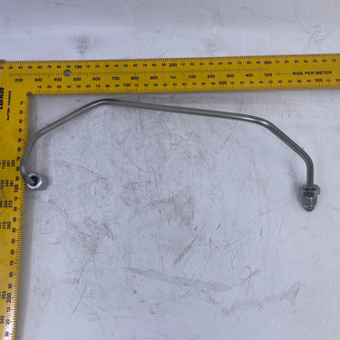 A curved metal bracket with two bolted ends, shown on a scratched white surface next to a yellow L-square ruler for scale.