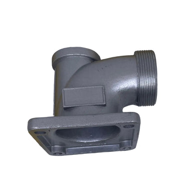 A gray metal pipe fitting with a square flange and threaded connection, shown next to yellow tape measures on a scratched white surface.