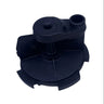 A black plastic pump or dispenser component with a circular base and a cylindrical top opening, photographed on a light gray surface.