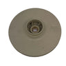 A beige plastic circular component with a central hub, photographed on a scratched light gray surface.