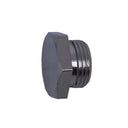 A small silver metal threaded component, possibly a valve stem or connector, placed on a scratched, light gray metal surface.