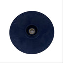 A round black rubber grommet or drain plug with a brass center screw, shown on a scratched, light gray metal surface.
