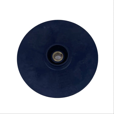A round black rubber grommet or drain plug with a brass center screw, shown on a scratched, light gray metal surface.