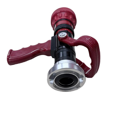 A red and black fire hydrant-style nozzle with a silver metal connector, placed on a light wood tabletop.