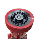 A close-up of a red and black fire hydrant coupler being held by a person's hand on a light wood table in an office setting.