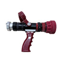 A red and black fire hose nozzle with a silver metal connector, resting on a light wood-grained surface.