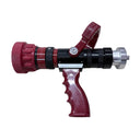 A red and black fire hose nozzle with a red handle, resting on a light wood-grained surface.